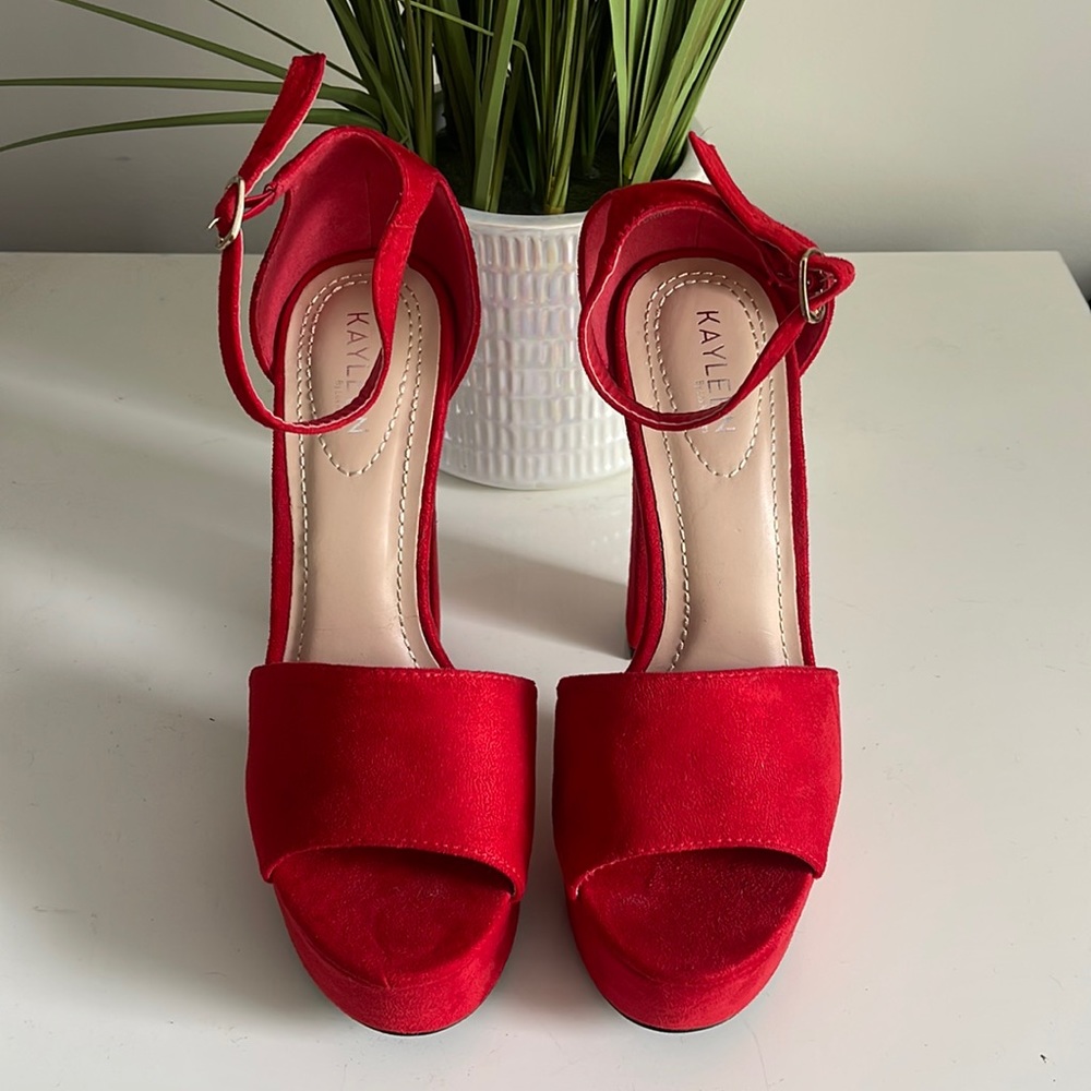 Red platform heels, never worn